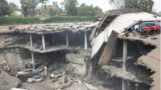 For dis handout photo wey dey provided by di Kenyan Presidential Press Service, di remains of cars and oda debris fit dey seen in a general view photographed from di rooftop, of di parking lot outside di Westgate Mall on September 26, 2013 for Nairobi, Kenya