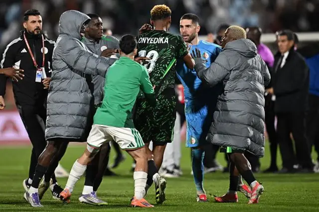 Nigeria midfielder Raphael Onyedika and Algeria goalkeeper Luca Zidane and players dey argue during di Africa Cup of Nations quarter-final football match between Algeria and Nigeria for di Grand stadium for Marrakesh on January 10, 2026