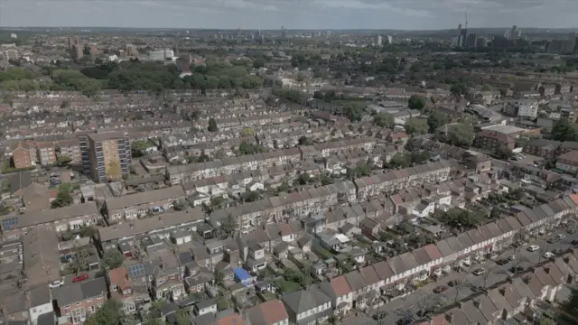 A still of aerial drone shot wey show houses near di Greenway for east London.