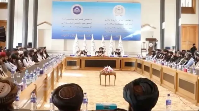 وزیر خارجه طالبان در جمع شمار زیادی از کارمندان و دیپلماتهای وزارت خارجه طالبان دیده میشود.