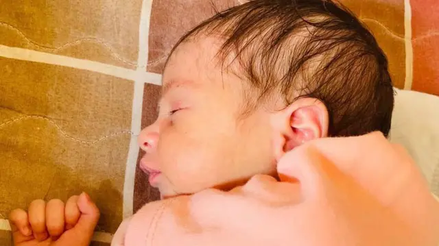 A close-up of a sleeping newborn baby