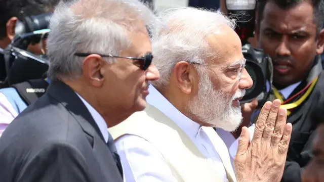 Indian Prime Minister Narendra Modi (L) greets as Sri Lankan Prime minister Ranil Wickremesinghe looks on at Bandaranaike International Airport, Sri Lanka. Sunday 9 June 2019