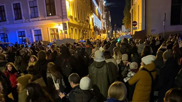 Толпа людей в теплой одежде на узких улочках Риги.