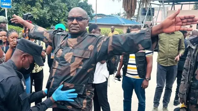 Hampande y'abasoda ba FDLR batobato, hari n'intwazangabo nkuru nkuru zifatwa zigatahukanwa. Uyu ni Brig Gen Gakwerere asakwa n'umupolisi w'Urwanda inyuma y'uko M23 imushikirije Urwanda ku wa 1 z'ukwa gatatu 2025