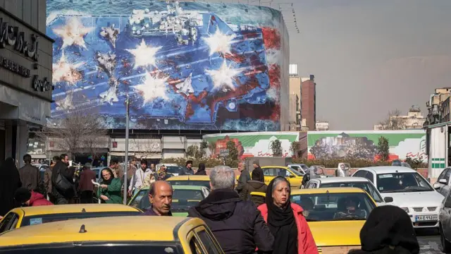 Bir devlet binası USS Abraham Lincoln'ün yok edildiğini gösteren, ABD karşıtı bir billboard ile kaplı. (Tahran, 28 Ocak 2026)
