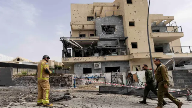 An emergency work in front a damaged apartmnent complex