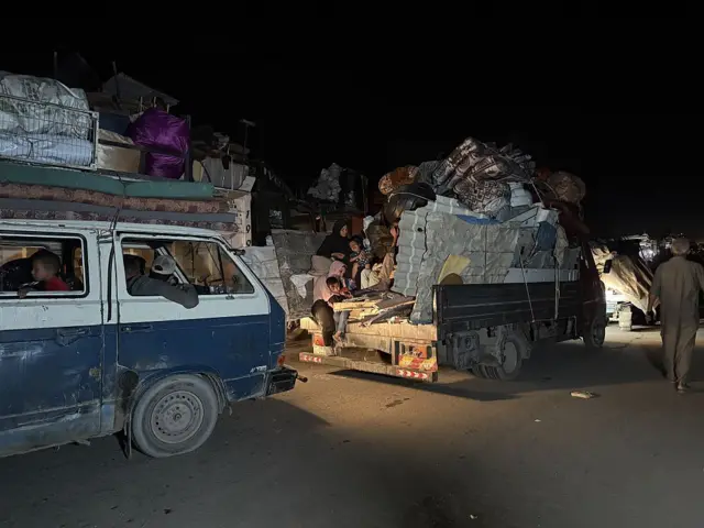 Palestinians move toward central Gaza using vehicles, horse carts, and travelling on foot. Vehicles can be seen at night with belongings piled high on their roof racks and heavily loaded trucks
