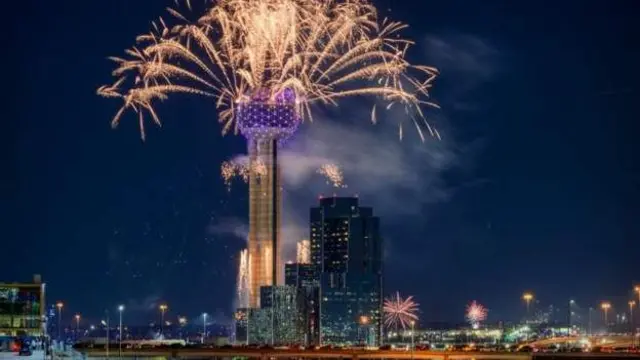 Dis na di view from Dallas as fireworks light up di city skyline for di celebrations