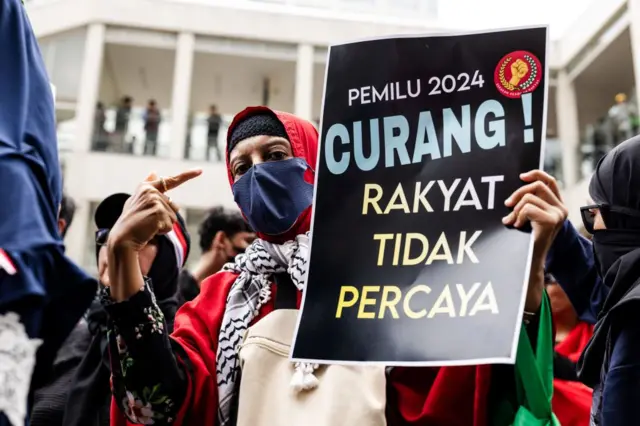 Para pengunjuk rasa meneriakkan slogan-slogan menentang dugaan kecurangan dalam pemilu presiden 14 Februari di luar kantor Bawaslu di Jakarta.
