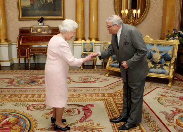 Restricted use: This image can only be used within 30 days of the upload date. Britain's Queen Elizabeth presents artist David Hockney with the Order of Merit at Buckingham Palace, in central London May 22, 2012.