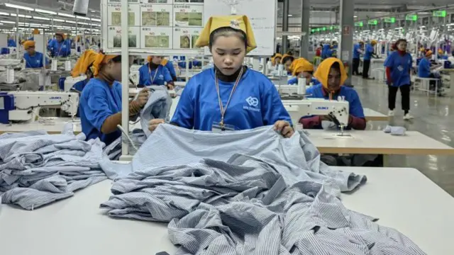 कंबोडिया में एक चीनी स्वामित्मव वाली एक फ़ैक्ट्री में काम करती महिला