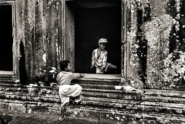 KHAO PHRA VIHARN, CAMBODIA - 1998/05/05: Children play inside the stone windows of Khao Phra Viharn, an ancient Khmer temple that is situated on the Thai-Cambodia border and is claimed by both countries. In 1962 the World Court awarded the temple to Cambodia. Although tensions remain high, growing numbers of tourists come here.. (Photo by Ben Davies/LightRocket via Getty Images)