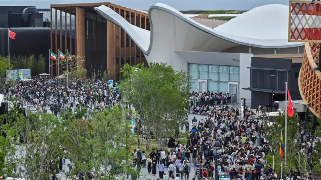 An image showing a crowd of people outside the pavilions at Expo 2025 in Osaka, Japan.