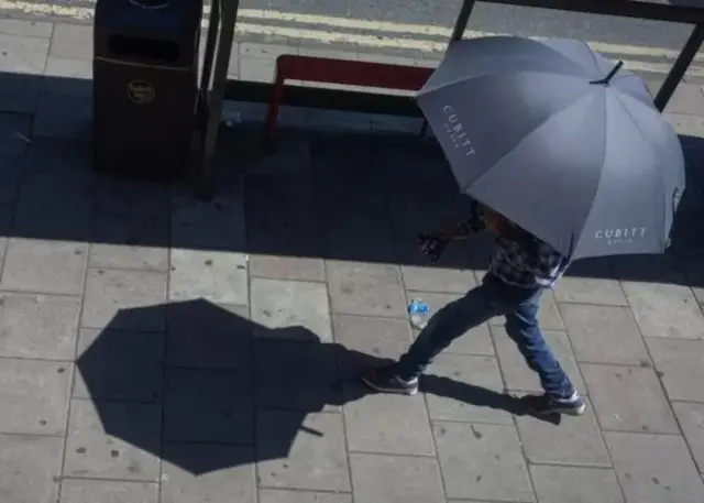 Une personne marchant sous un parapluie