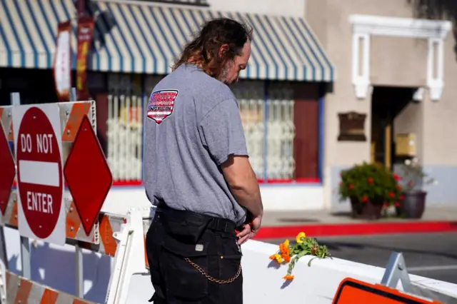 घटनास्थलबाहिर प्रार्थना गर्दै एक व्यक्ति