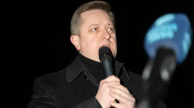 Василь Зварич у чорному пальті з мікрофоном