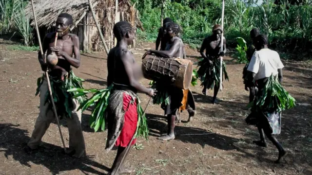 Members of the Chabu community playing traditional music, moving in a circular pattern.