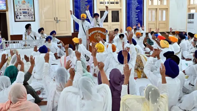 শিখ ধর্মাবলম্বীদের একটি সমাবেশের ছবি যেখানে অনেকেই হাত উঁচু করে আছেন