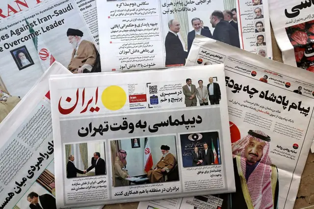 چند صفحه اول روزنامه‌های ایران مورخ ۱۹ آوریل ۲۰۲۵ روی یک دکه روزنامه‌فروشی در تهران دیده می‌شود. تیترهای درشت و تصاویر اصلی روزنامه‌ها به مذاکرات هسته‌ای ایران و آمریکا اختصاص دارد و عکس‌هایی از دیدار مقام‌های ایرانی و خارجی در صفحه‌های نخست دیده می‌شود. روزنامه‌ها روی هم چیده شده‌اند و فضای یک دکه خیابانی را نشان می‌دهند.