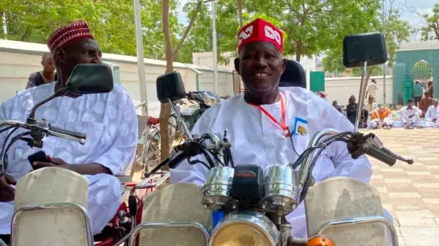 Two men dey ride bike
