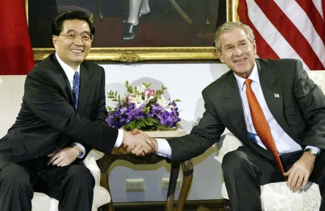 OPSHOT - China's President Hu Jintao and US President George W. Bush(R) shake hands during a bi-lateral meeting 19 October 2003 prior to the start of the Asian Pacific Economic Cooperation(APEC) in Bangkok, Thailand. AFP Photo/Paul J. RICHARDS (Photo by PAUL J. RICHARDS / AFP) (Photo by PAUL J. RICHARDS/AFP via Getty Images)
