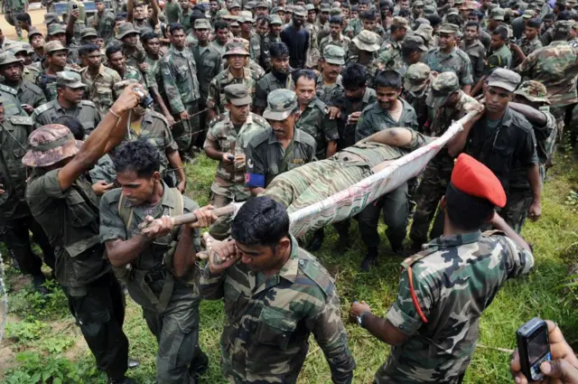 2009 මැයි 19 වන දින මුලතිව් දිස්ත්‍රික්කයේ LTTE නායක වේළුපිල්ලේ ප්‍රභාකරන්ගේ දේහය රැගෙන යන ශ්‍රී ලංකා සොල්දාදුවන්.