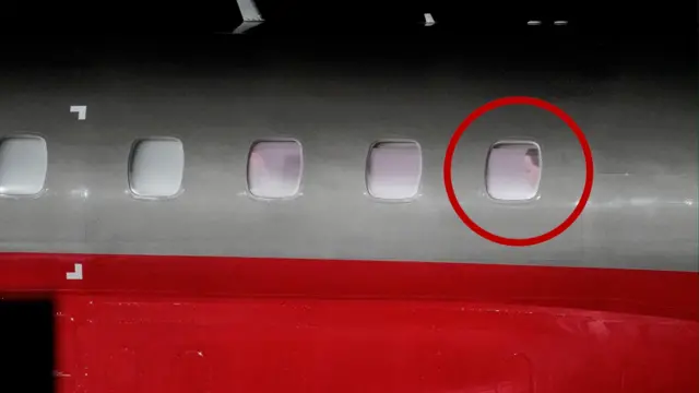 A red and white plane where Machado can be seen at the last window, with a graphic red circle superimposed around it