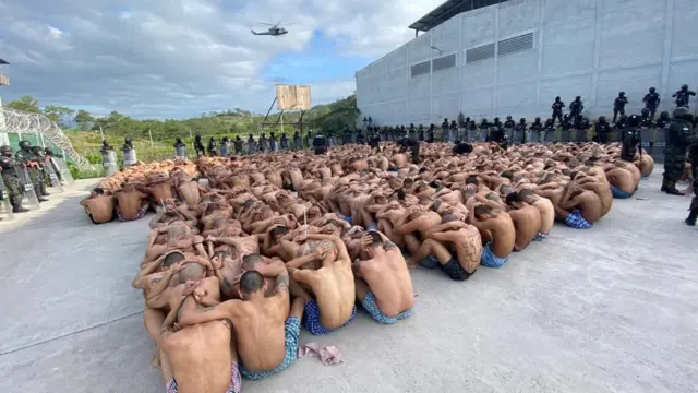 Centenasbrazino entrarprisioneiros são supervisionados pela polícia militar hondurenha