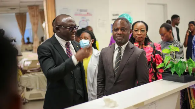 health minister being briefed by management of the Ridge hospital upon a facility visit 