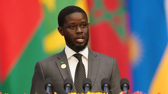 Senegal President Bassirou Diomaye Faye wear one black suit, white shirt and black tie.