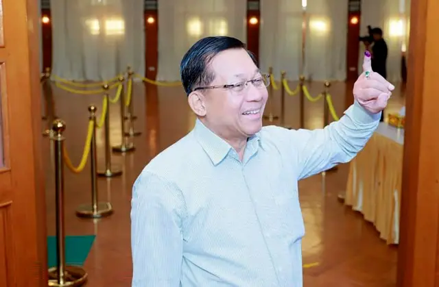 Myanmar military chief Senior General Min Aung Hlaing displaying his ink-marked little finger after casting a ballot