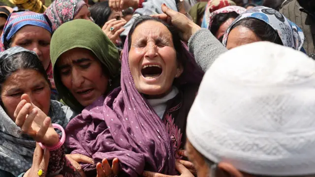 A family member opens her mouth in grief during Adil Hussain Shah's funeral in Hapatnur, Anantnag district, India, on 23 April 2025
