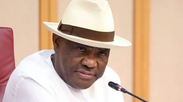 FCT minister Nyesom Wike wear white dress wit hat