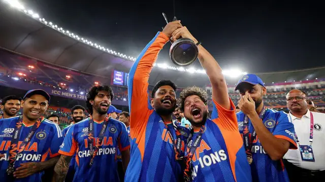 Kuldeep Yadav and Sanju Samson of India celebrate after victory in the ICC Men's T20 World Cup India & Sri Lanka 2026 Final between India and New Zealand at Narendra Modi Stadium on March 08, 2026 in Ahmedabad, India. 