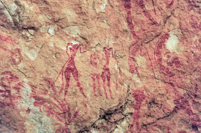 Rock painting depicting women, Tassili N'Ajjer National Park, Tadrart Rouge, Algeria. The Tassili n'Ajjer is known for its prehistoric rock art, which is dated between 9,000 and 10,000 years ago. The inhabitants of these areas could easily obtain the pigments they needed to paint, obtaining them from materials available in the area, the most common being red pigments.