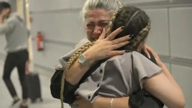 Setareh and Sepideh hugging at Dusseldorf Airport 