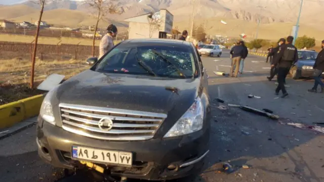 A car with bullet holes in the windscreen
