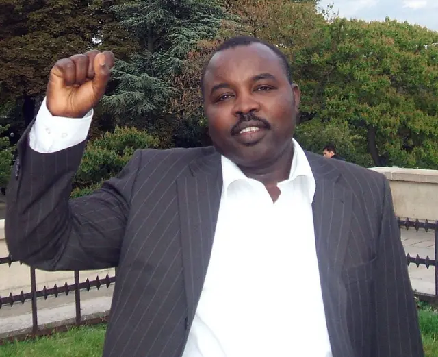 رئيس حركة تحرير السودان في دارفور عبد الواحد محمد نور يقف رافعاً بده اليمنى وملوحاً بعلامة النصر