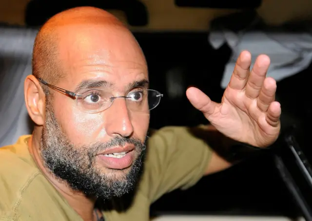 Saif Al-Islam / Seif al-Islam, son of Libyan leader Muammar Gaddafi, gestures as he talks to reporters in Tripoli August 23, 2011
