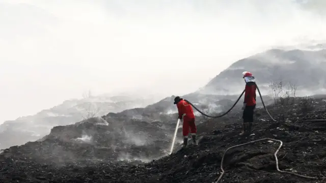 Personil gabungan berjibaku memadamkan api kebakaran di TPA Jatiwaringin, Kabupaten Tangerang, dengan menggunakan semprotan air pada Senin (6/7).