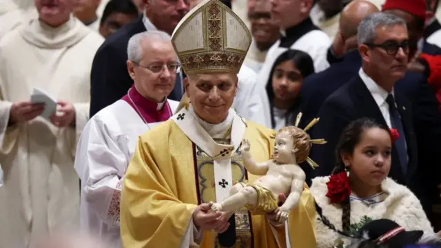 Pope Leo hold one figurine of Baby Jesus during Christmas Eve Mass in St Peter's Basilica for di Vatican, Italy