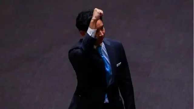 Pita Limjaroenrat, leader of the Move Forward Party gestures at parliament after Thailand"s Constitutional Court ordered his temporary suspension from the parliament, on the day of the second vote for a new prime minister, in Bangkok, Thailand, July 19, 2023.
