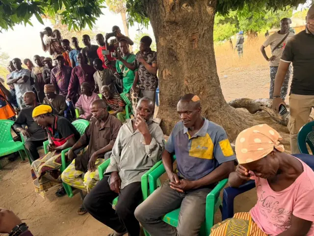 Residents of Kurmin Wali village looking forlon gathered at the square where they were to be addressed by the State governor