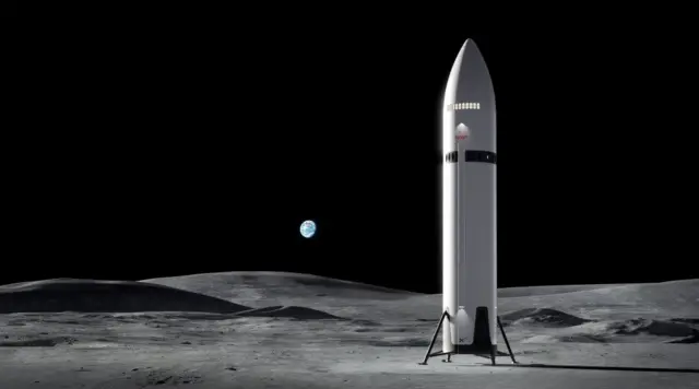 A computer-generated illustration depicts a large, gleaming silver spacecraft against the black void of space, with the curved grey surface of the Moon visible below. The spacecraft is enormous: a sleek, cylindrical structure dominated by a rounded nosecone at the top, where the crew compartment is located some 35 metres above the lander's base. Fins extend from the lower section. Stars and the distant Earth are just visible in the background. 