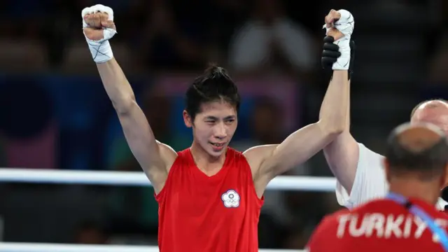 Lin Yu-ting holding her hands in the air after winning a boxing match at the Olympic Games