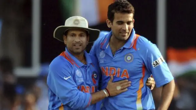 Indian cricketer Sachin Tendulkar(L) wearing team India's official blue jersey and a steel bracelet and a hat congratulates teammate Zaheer Khan who is wearing the Indian cricket team's jersey after taking the wicket of unseen Australian batsman Cameron White during the quarter-final match of The ICC Cricket World Cup 2011 between India and Australia at The Sardar Patel Stadium, Motera in Ahmedabad on March 24, 2011.
