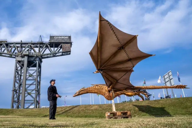 Pilot and technician Dennis Gutowsky alongside the animatronic model of House of the Dragon's Syrax that was flown over the SEC (Scottish Event Campus), the venue where several sports are being hosted in Glasgow, to celebrate the opening of the 2026 Commonwealth Games. Picture date: Wednesday July 22, 2026. PA Photo. Photo credit should read: Jane Barlow/PA Wire