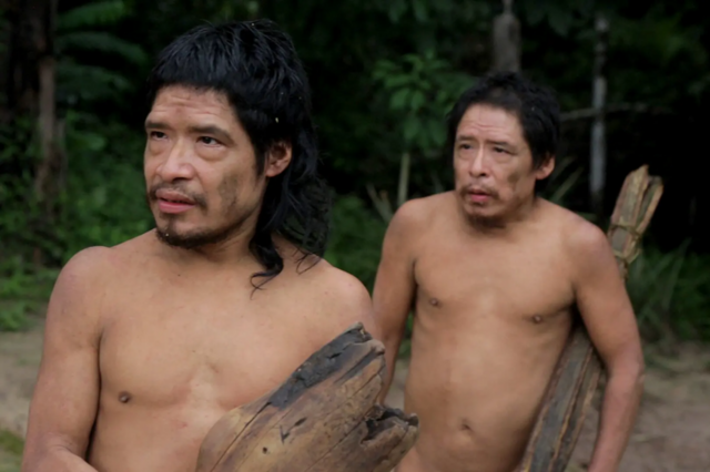 Dois homens indígenas segurando peças de madeira
