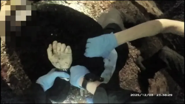Un hombre siendo esposado por la espalda.