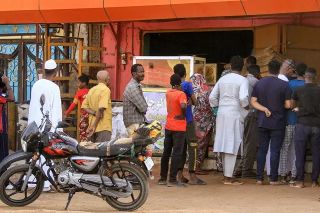 Des personnes font la queue pour acheter du pain devant une boulangerie à Khartoum.
